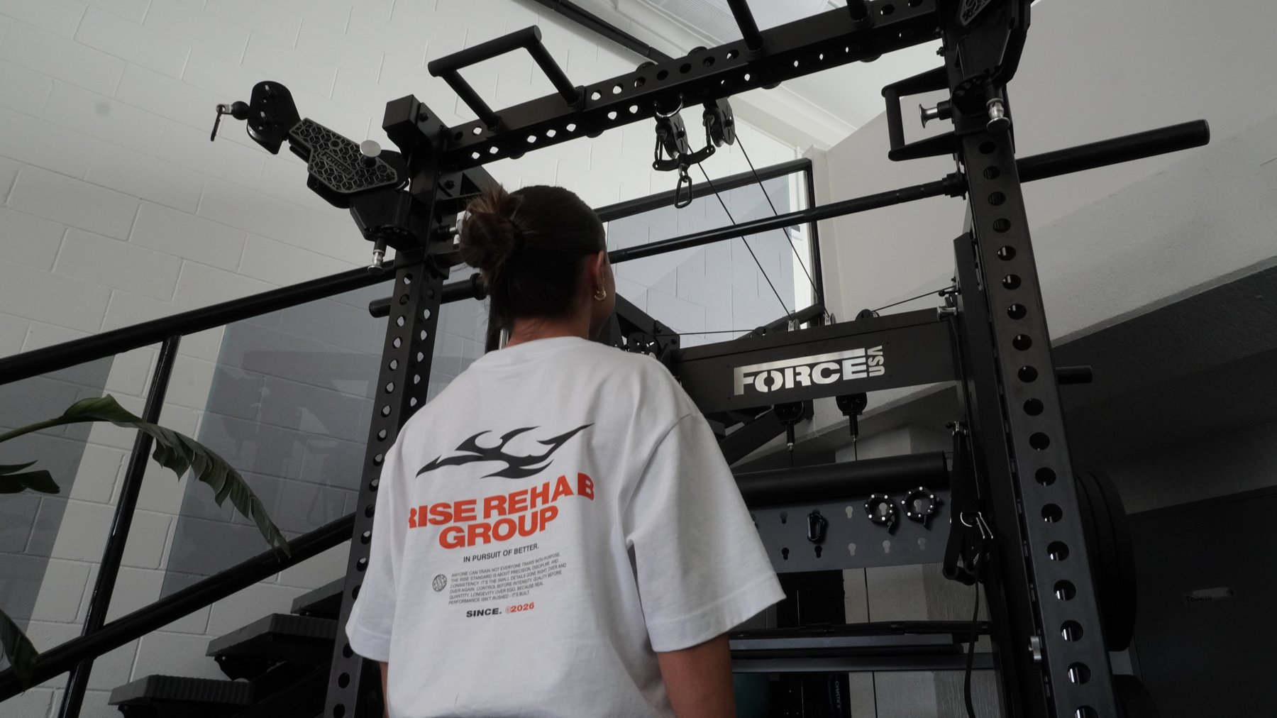 Isabelle McMullen looking up at the rig in a Rise Rehab Group branded t-shirt