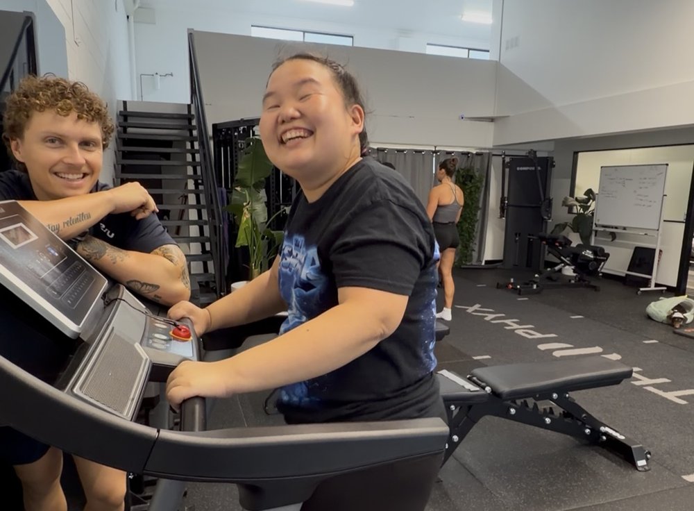 Zak Bowdler coaching an NDIS participant on the treadmill at the Burleigh Heads clinic