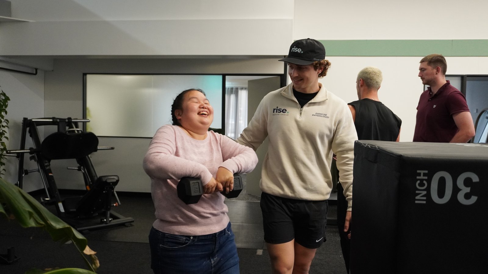 Zak Bowdler celebrating a milestone with an NDIS client at Rise Rehab Group's Burleigh Heads location