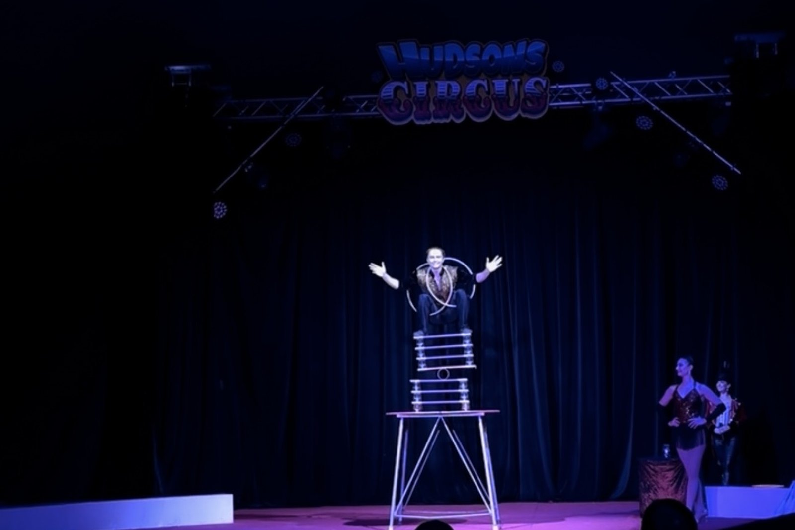 Zak Bowdler performing a balance act on stage at Hudsons Circus